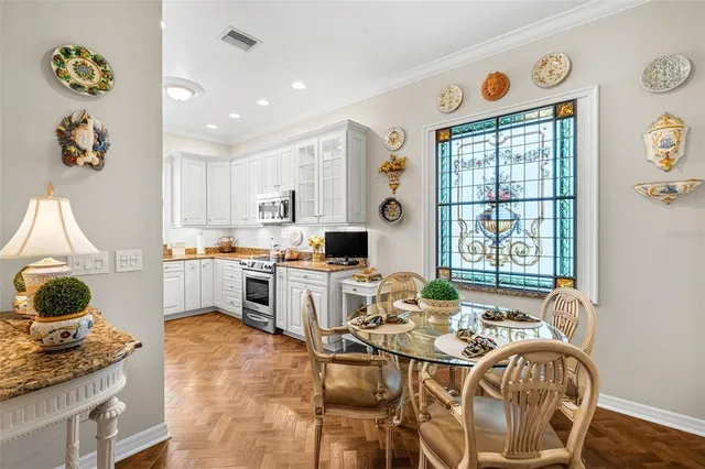 a view of a dining room with furniture a chandelier and wooden floor