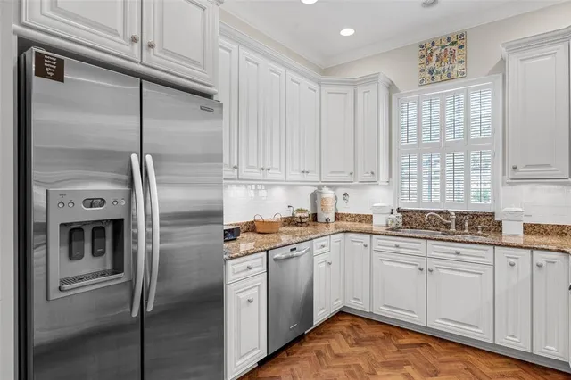 a kitchen with a sink stainless steel appliances and cabinets