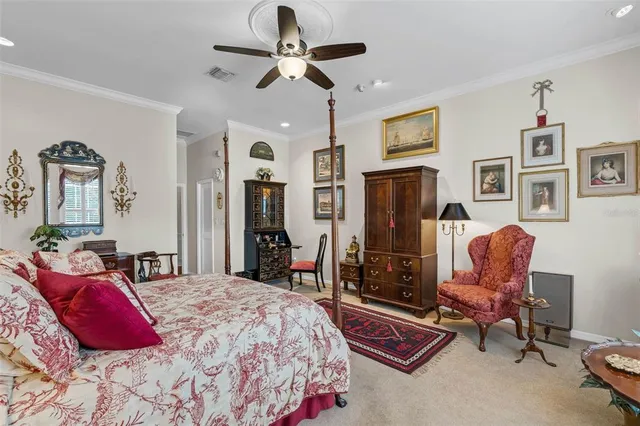 a bedroom with a bed large mirror and furniture