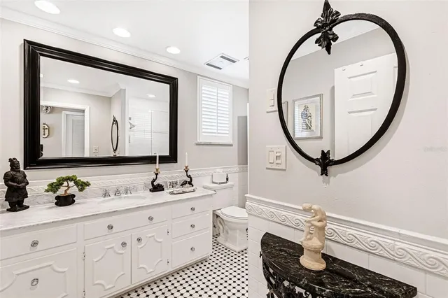 a bathroom with a sink a mirror and a toilet