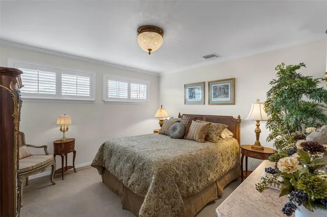 a bedroom with a bed and a potted plant