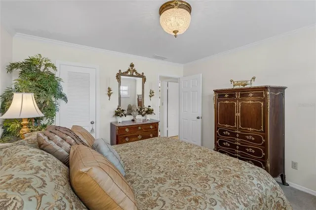 a bedroom with a bed and a television