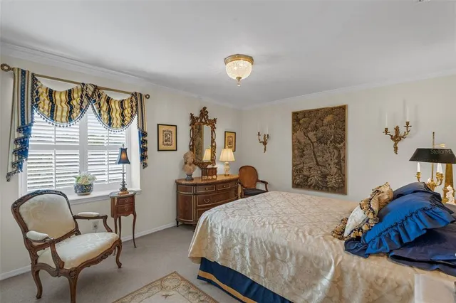 a bedroom with a bed and a chair