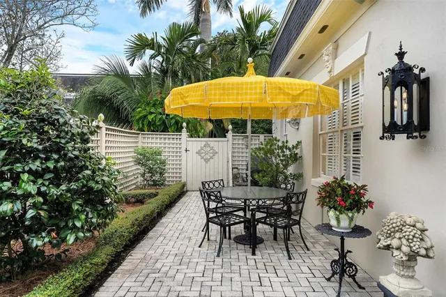 a view of a chair and table in the patio with a backyard