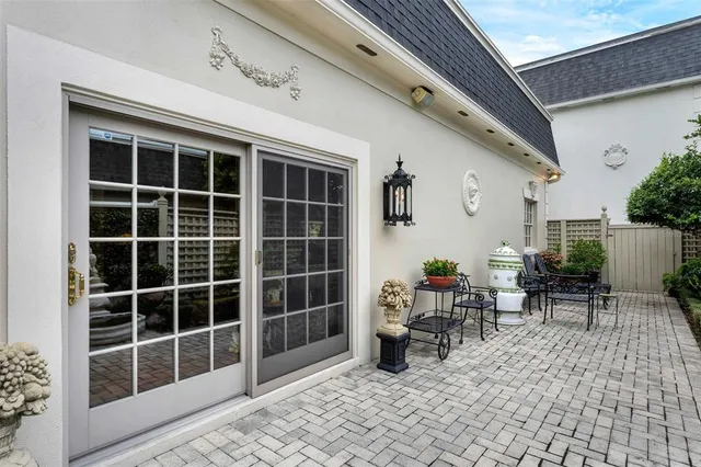 a view of a porch with chairs and potted plant