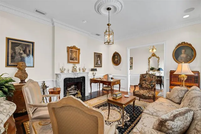 a living room with furniture a fireplace and decor