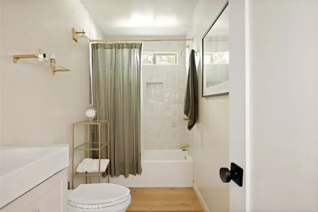 a bathroom with a toilet a sink and bathtub