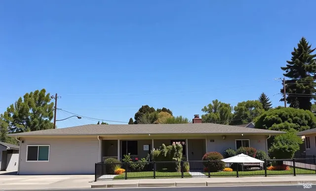 a front view of a house with a yard