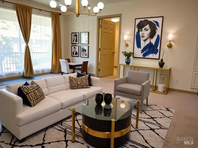 a living room with furniture a large window and a chandelier