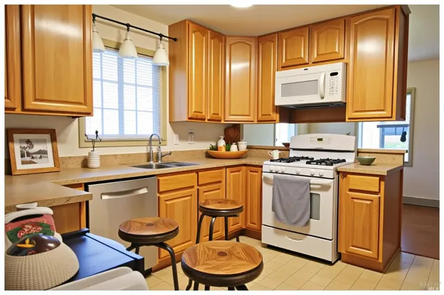 a kitchen with a stove a sink and a refrigerator