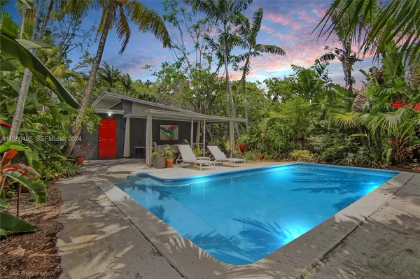a view of house with swimming pool