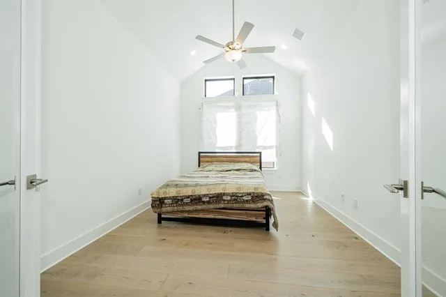 a view of bedroom and bedroom with wooden floor