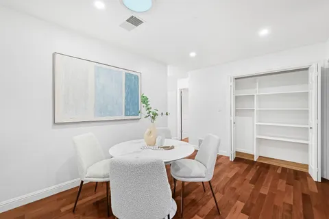 a view of a dining room with furniture and wooden floor