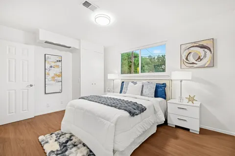 a bedroom with a bed and a window