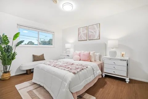 a bedroom with a bed and a painting on the wall