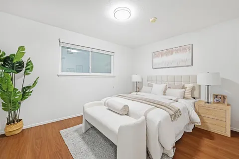 a bedroom with a bed and a potted plant