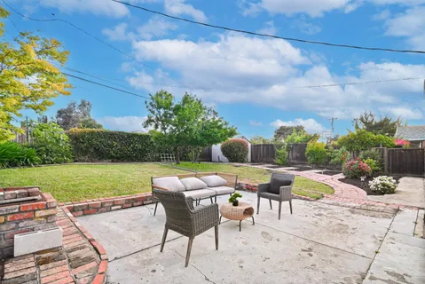a swimming pool with outdoor seating and yard
