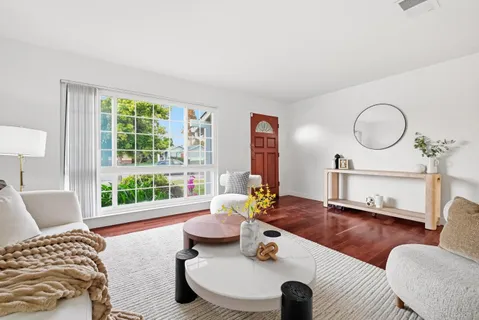 a living room with furniture and a large window