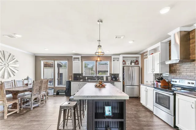 a view of a kitchen with dining table and chairs