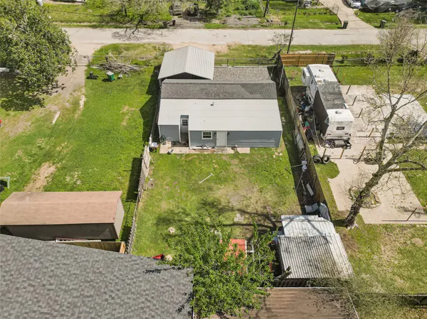 a view of a lake with a floor to ceiling window next to a yard