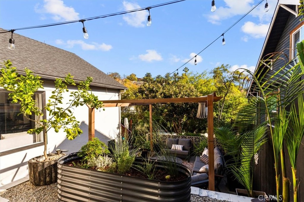 2207-2009 Apex Avenue Los Angeles, CA 90039 - Photo 27 of 64 String lights and a fire pit in this entertainment space bring cozy and warm feels to a multifunctional outdoor space.