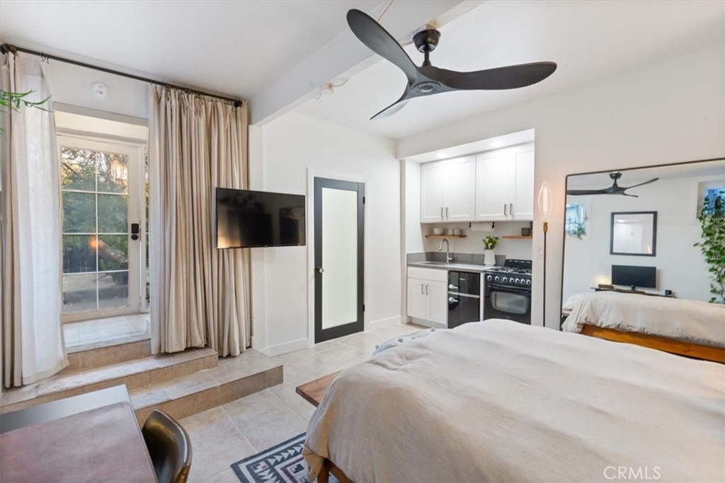 2207-2009 Apex Avenue Los Angeles, CA 90039 - Photo 37 of 64 Pull the curtain to the left for some privacy and you have a studio equipped with a 3/4 bathroom, kitchen, celing fan, queen sized bed and a quaint office area.