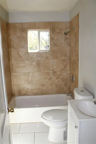 a bathroom with a sink a toilet and a bathtub