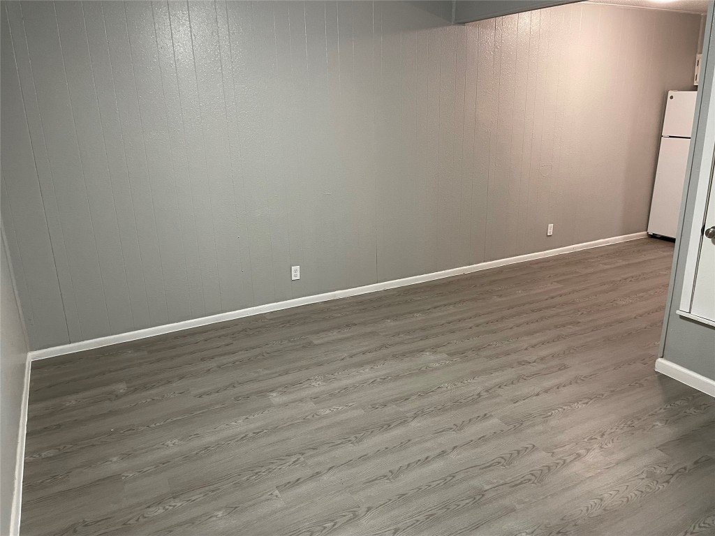 1209 Vance Street, Unit 30 Taylor, TX 76574 - Photo 24 of 35 a view of an empty room with wooden floor