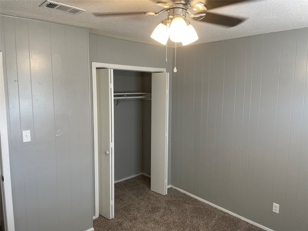 1209 Vance Street, Unit 30 Taylor, TX 76574 - Photo 28 of 35 a view of an empty room with a chandelier fan