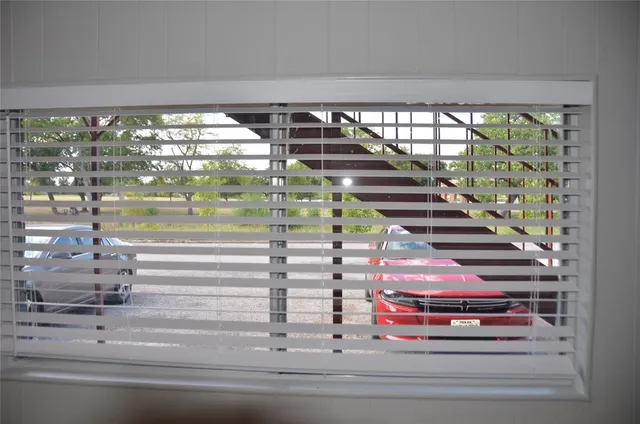 a utility room with a floor to ceiling window and an outdoor view