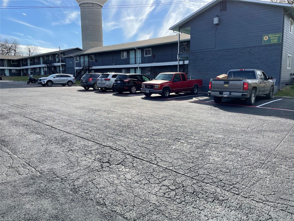 1209 Vance Street, Unit 30 Taylor, TX 76574 - Photo 32 of 35 a car parked in front of a building