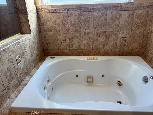 a bathroom with a tub and a shower