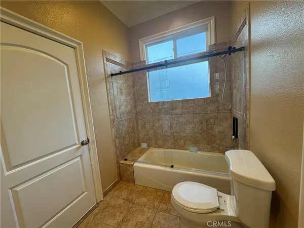 a bathroom with a toilet and a bathtub