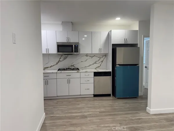 a kitchen with a stove microwave and cabinets