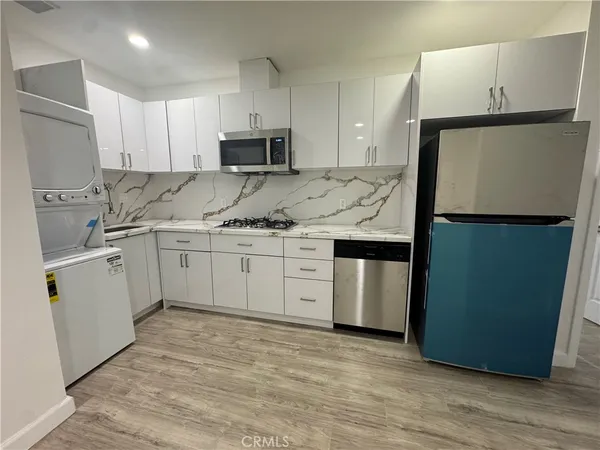 a close view of a sink and refrigerator