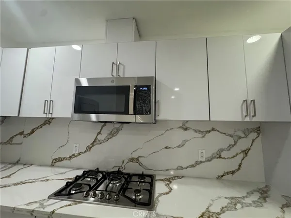 a white toilet sitting next to a shower