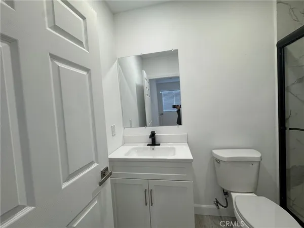 a bathroom with a sink toilet and a mirror