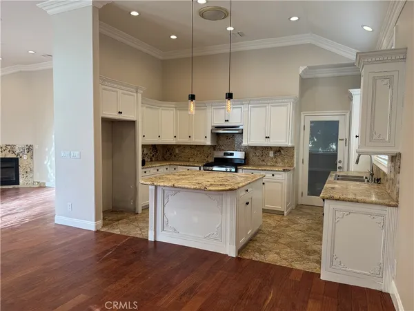 a kitchen with white cabinets and appliances