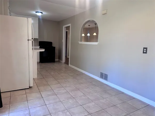 a kitchen with a cabinets and a refrigerator