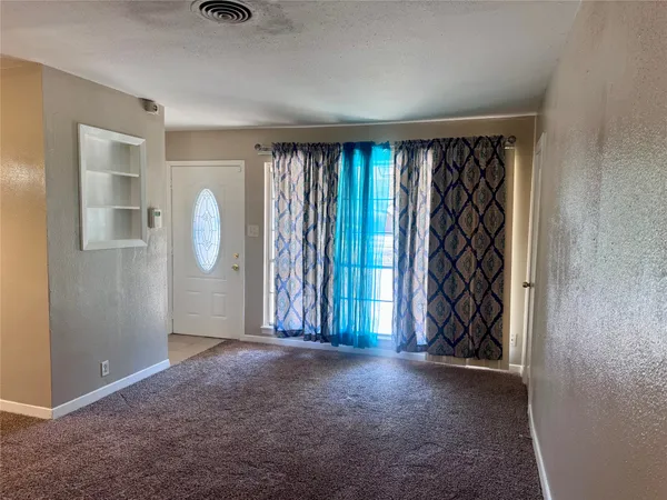 an empty room with windows and closet