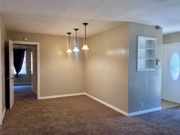 an empty room with closet and a chandelier fan