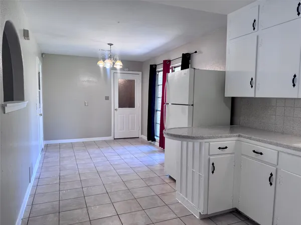 a kitchen with a refrigerator a stove and cabinets