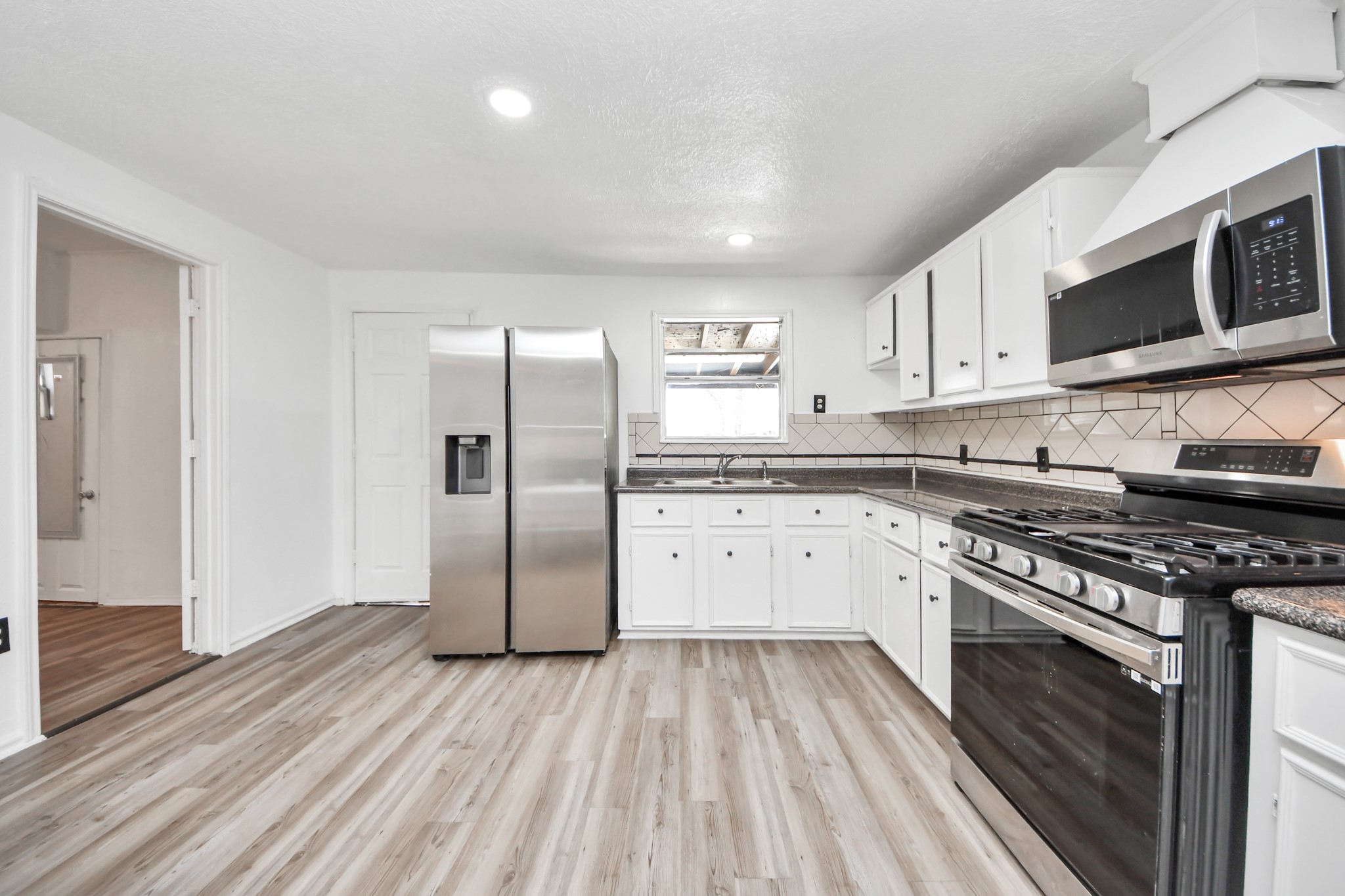 602 Massey Tompkins Road Baytown, TX 77521 - Photo 5 of 15 a kitchen with stainless steel appliances granite countertop a stove a sink and a refrigerator