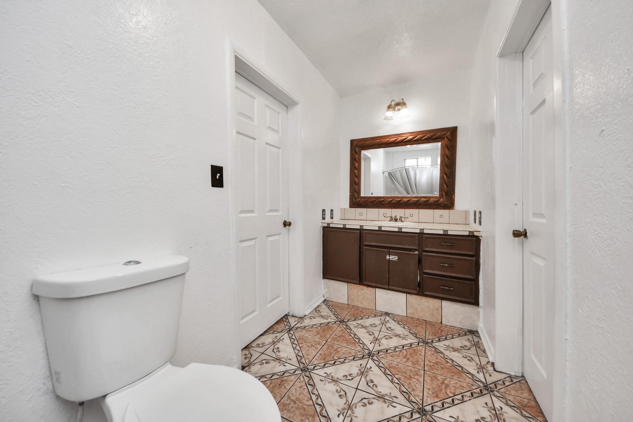 602 Massey Tompkins Road Baytown, TX 77521 - Photo 9 of 15 a bathroom with a toilet a sink and mirror