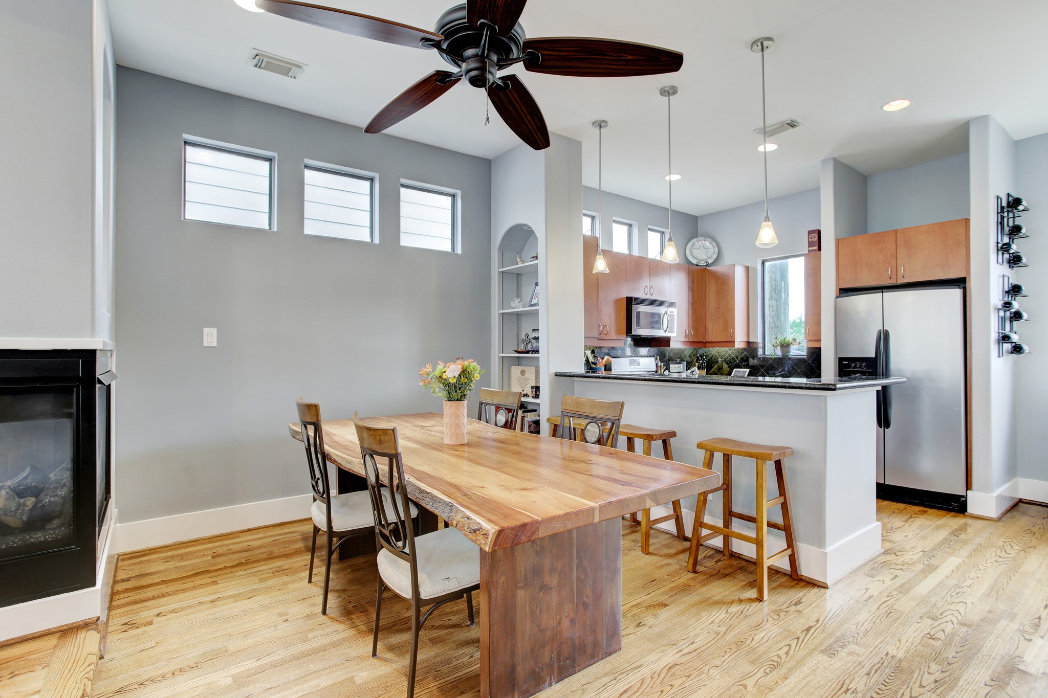 408 Parker Street Houston, TX 77007 - Photo 10 of 27 a dining room with stainless steel appliances kitchen island a table chairs and a refrigerator