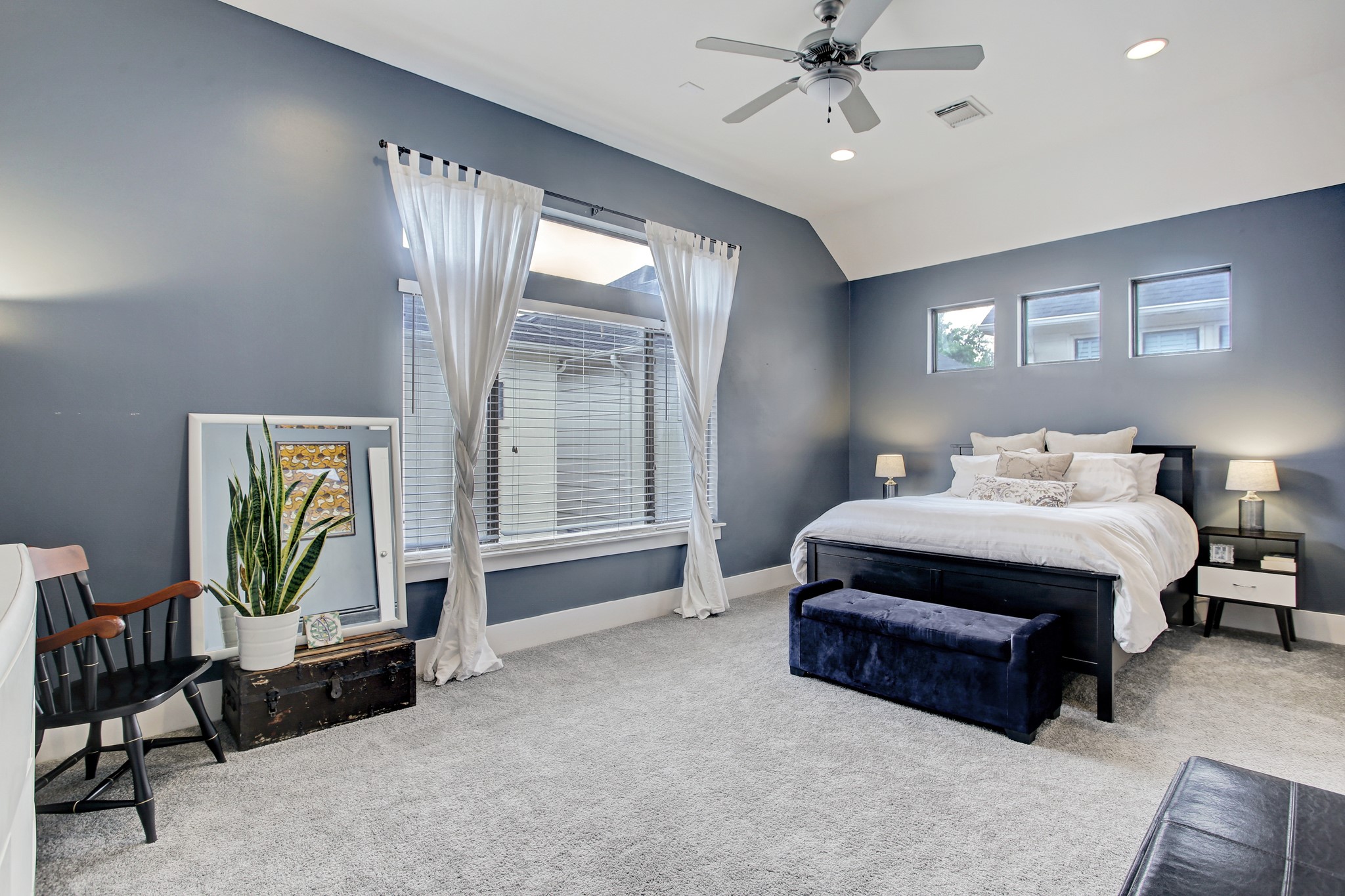 408 Parker Street Houston, TX 77007 - Photo 17 of 27 a spacious bedroom with a bed a couch and a chandelier