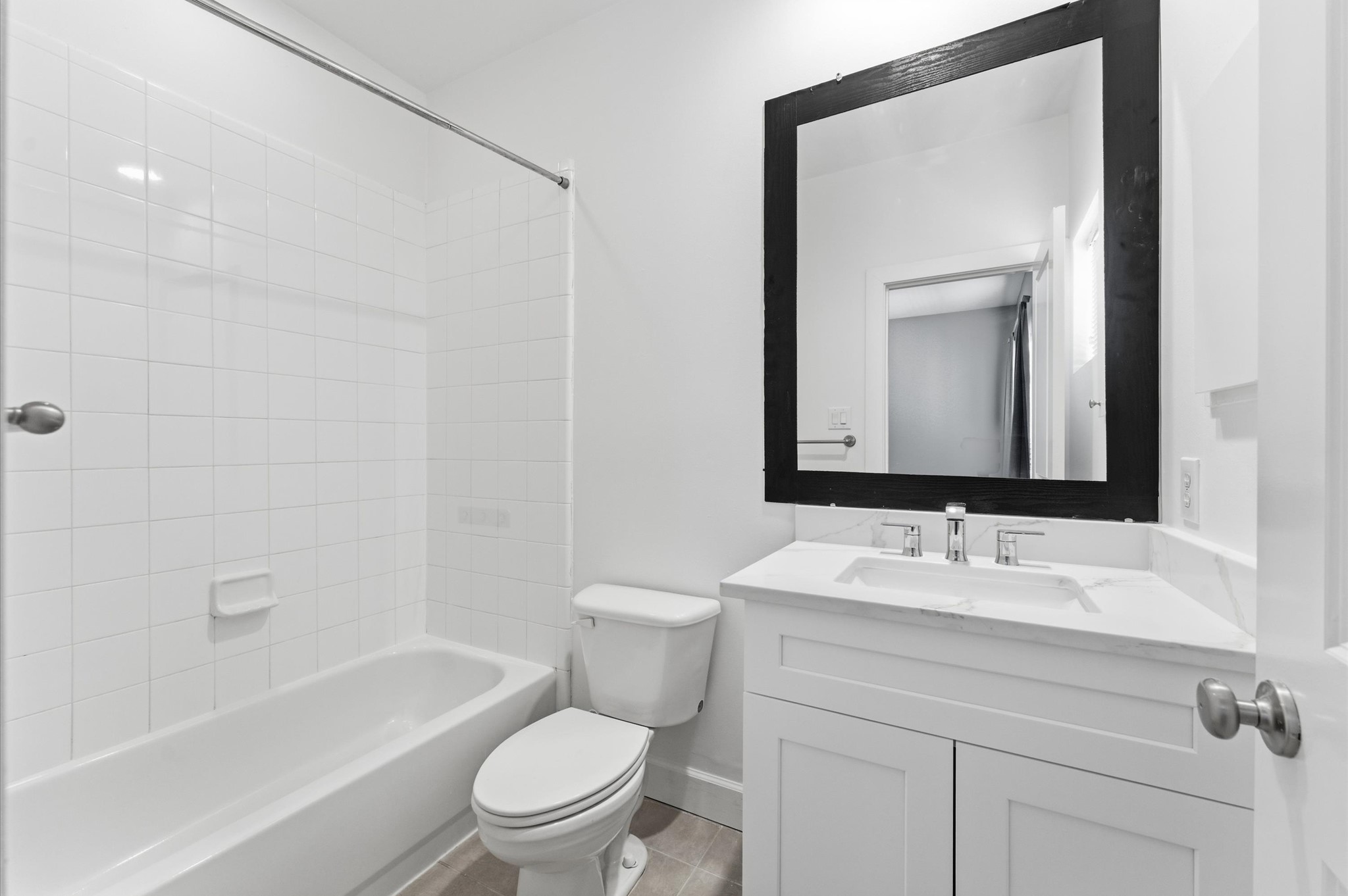 408 Parker Street Houston, TX 77007 - Photo 21 of 27 a bathroom with a granite countertop sink a toilet and a bathtub