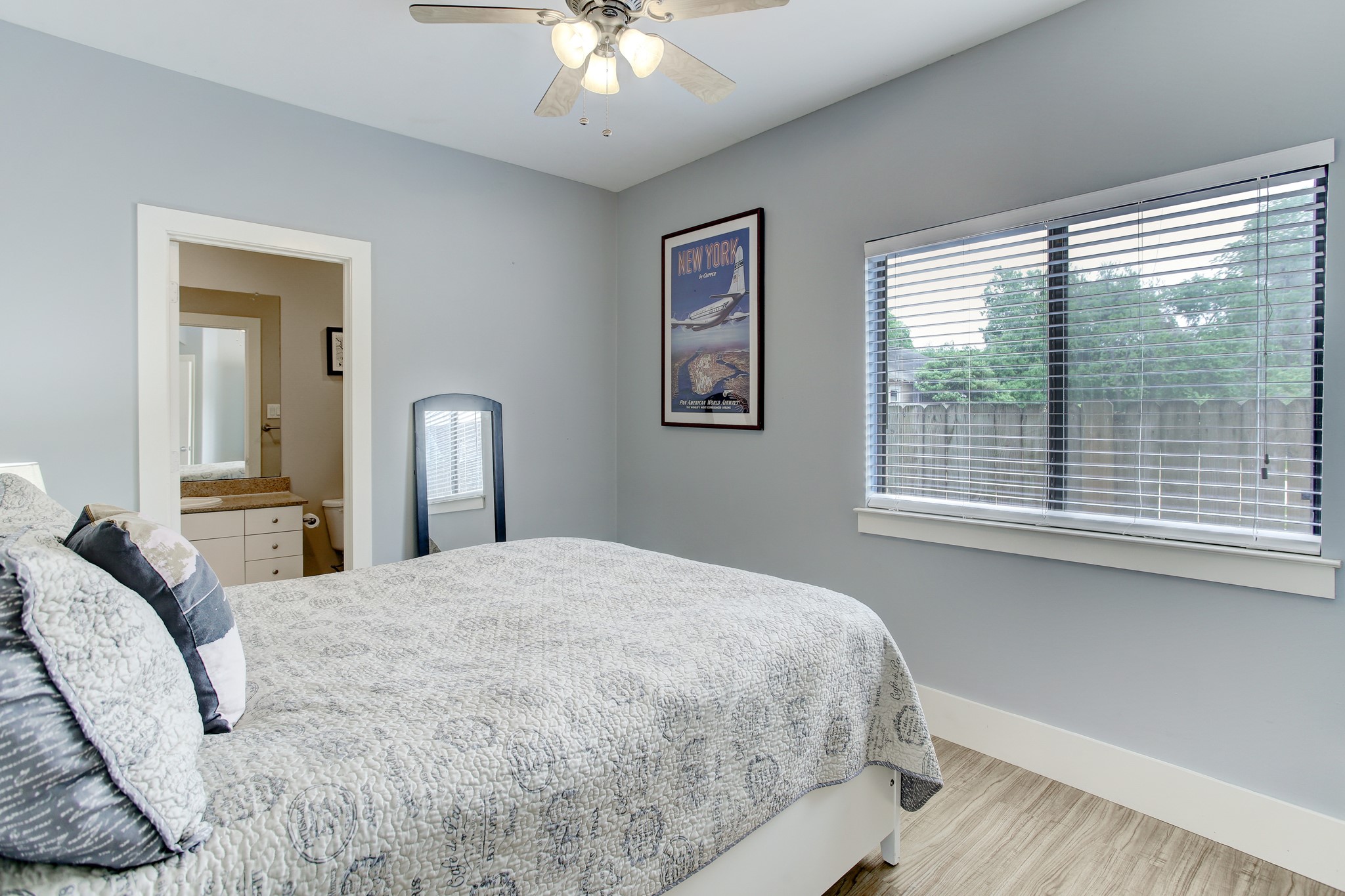408 Parker Street Houston, TX 77007 - Photo 4 of 27 a bedroom with a large bed and a chandelier