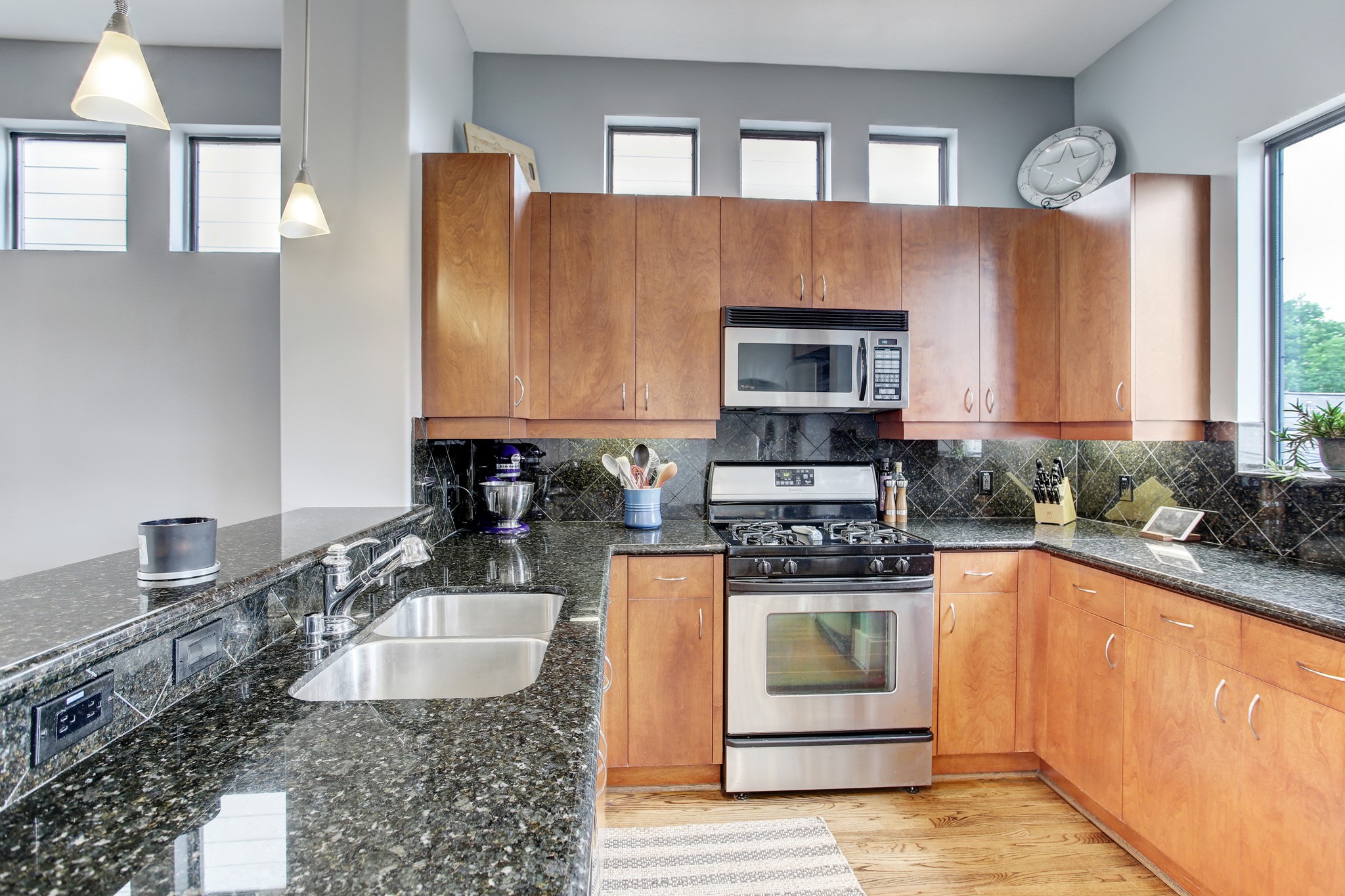 408 Parker Street Houston, TX 77007 - Photo 7 of 27 a kitchen with stainless steel appliances granite countertop a stove a sink and a microwave