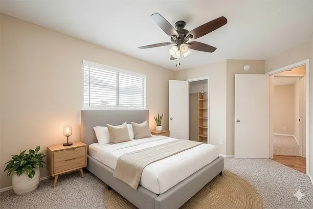 a bedroom with a bed chandelier and a window